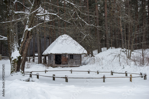Latvian old wooden house with elaborate wooden columns.
