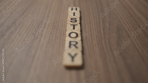 Wooden letters on the table with the word HISTORY written on them