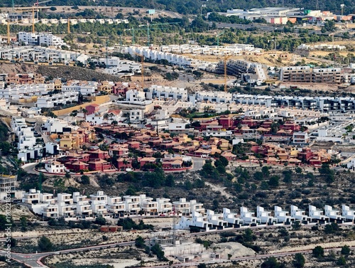фотографія White villas on dry hillside, Sprawling residential neighborhood on arid hillsid