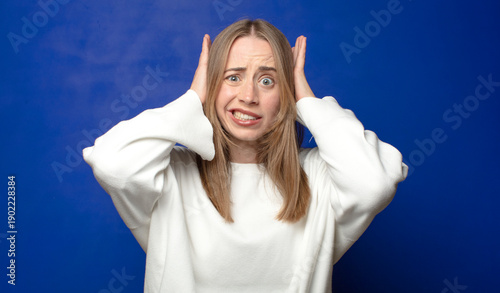 feeling stressed, worried, anxious or scared, with hands on head, panicking at mistake