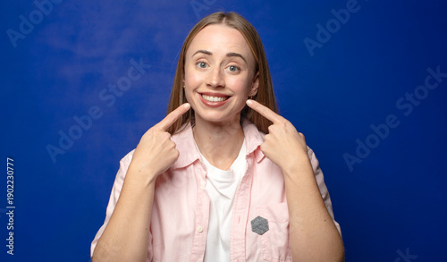 Photography smiling confidently pointing to own broad smile, positive, relaxed, satisfied at