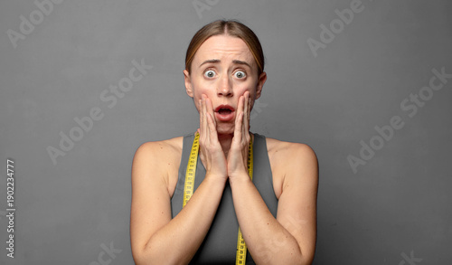 Obraz na plátne feeling shocked and scared, looking terrified with open mouth and hands on cheeks