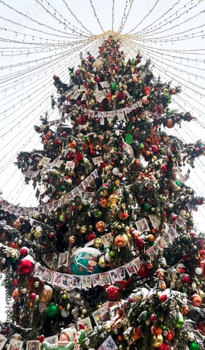 Fotografija Towering Christmas tree adorned with whimsical baubles and nostalgic tinsel, evo