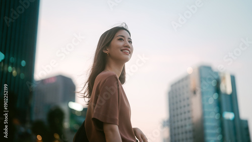 Positive beautiful smiling portrait single business asian woman standing at outdoors city building background