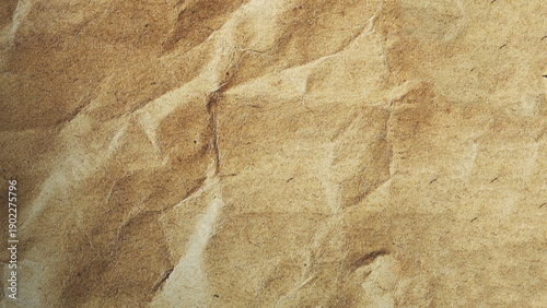 Brown crumpled kraft paper texture with deep folds and creases. Blank brown crumpled paper texture background, old page for craft design.