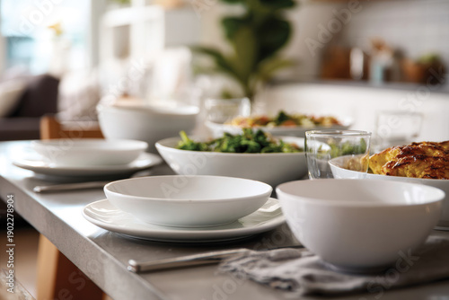 Wallpaper Mural A beautifully set dining table featuring an array of vibrant salads and plates in a well-lit, modern kitchen setting, inviting for a casual yet elegant meal experience. Torontodigital.ca