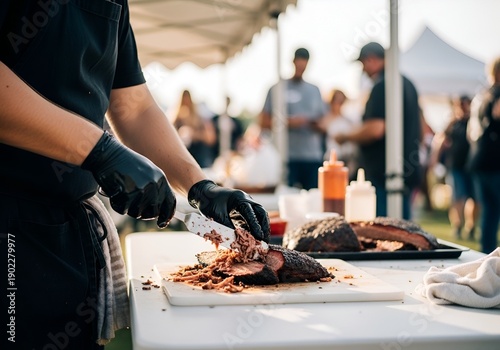 Chef expertly shreds slow-cooked barbecue meat at outdoor food festival stall