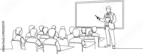 A teacher presenting to a group of students in a classroom setting with a projector screen.