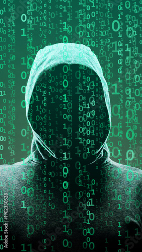 Computer hacker in mask and hoodie over abstract binary background. Obscured dark face. Data thief, internet fraud, darknet and cyber security.