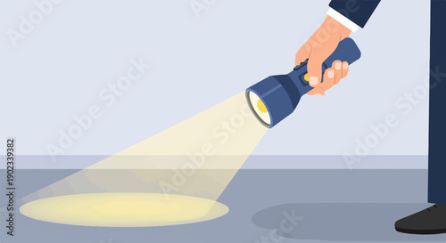Person in suit holding flashlight illuminating floor