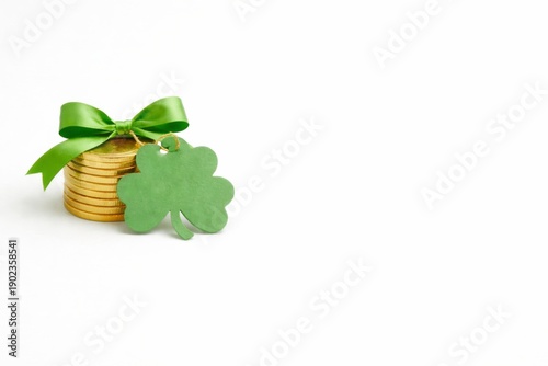 St patricks day themed coins and shamrock with green ribbon, copy space