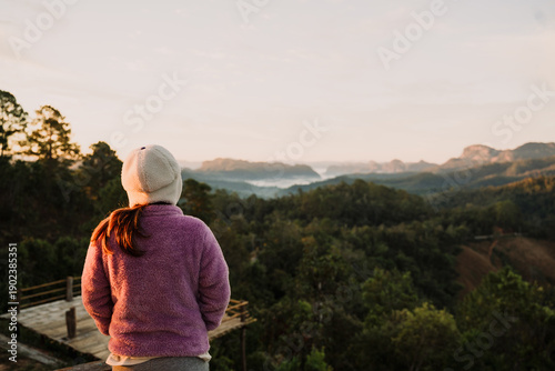 Close up woman looking the mountain View with Trees and Clouds  at sunrise.