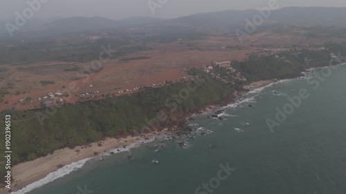 Wallpaper Mural Aerial view of Cabo de Rama cliff viewpoint and beach in South Goa, showing lush green cliffs, white sand beaches, ocean waves, the Arabian Sea, and abundant coconut trees during a calm winter season Torontodigital.ca