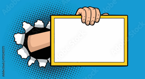 Pop art hand bursts through a blue halftone background, holding a blank yello...