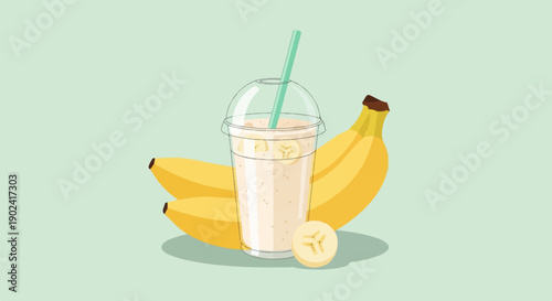 Refreshing banana smoothie in a clear cup with a straw and whole bananas