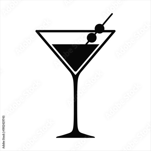 Elegant martini glass with olives and a cocktail stirrer on a white background