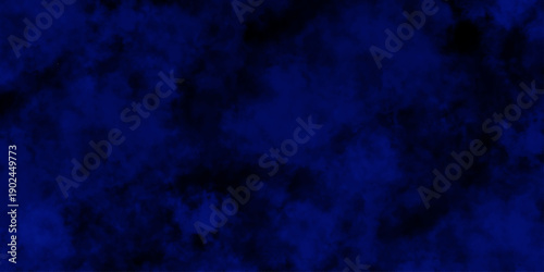 Artificial magic smoke in black and blue light on black background in darkness. light blue and dark blue background. Black and blue Grunge Concrete Wall Texture Background.