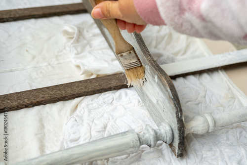Konstfotografi brush applying paint to old wooden furniture during furniture restoration, vinta