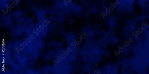 Artificial magic smoke in black and blue light on black background in darkness. light blue and dark blue background. Black and blue Grunge Concrete Wall Texture Background.