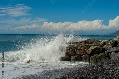 powerful waves crashing against the shore stones, a force of nature