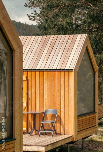 Wooden houses in a camping site among forests and mountains.