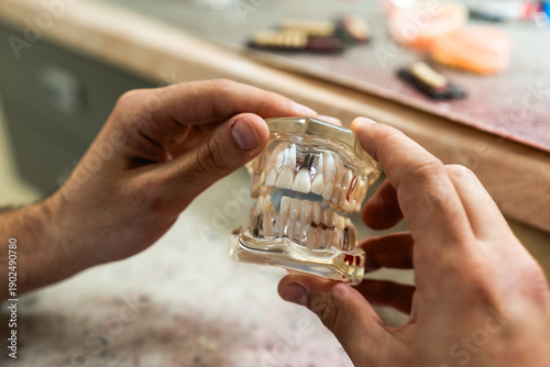 Fotografie A dental technician creates a denture model in a dental office.