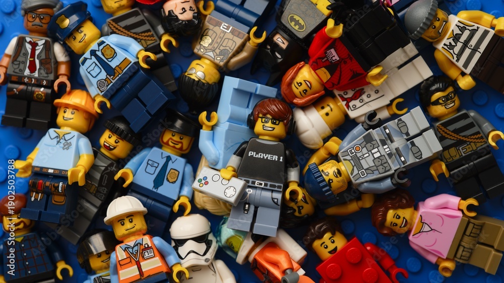 Obraz premium Tambov, Russian Federation - February 02, 2026 Heap of Lego minifigures on blue baseplate.