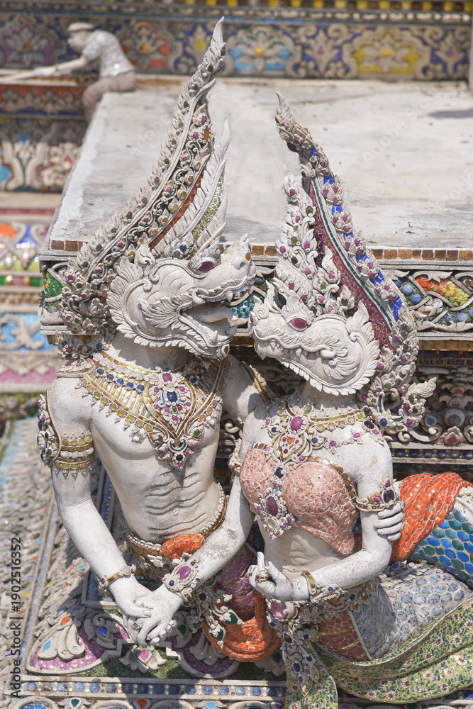 Fototapeta premium The contemporary stucco artwork in the Ordination Hall of Wat Pariwat Ratchasongkhram blends concepts related to beliefs and philosophy. Located at Bangkok city in Thailand.