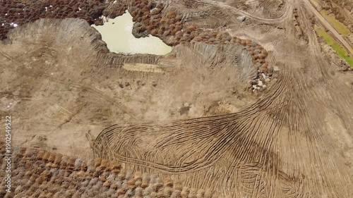 Flight over a developed sand quarry with waste dumps and ponds, bird's eye view
