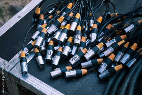 Ethercon network cables with rj45 connectors are gathered on a road case, highlighting equipment connectivity for audio-visual operations, broadcast production, and live event technical setups