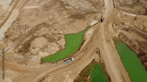 Truck traffic on sand quarry roads, aerial view

