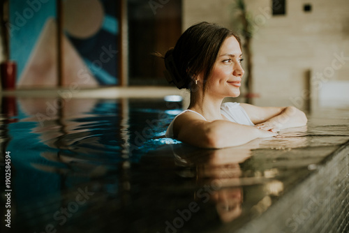 Woman relaxes in pool durin...