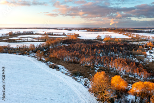 Aerial Drone View of Snowy Winter Countryside at Sunrise