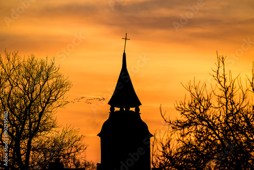 Church Tower Silhouette Against Dramatic Sunset Sky