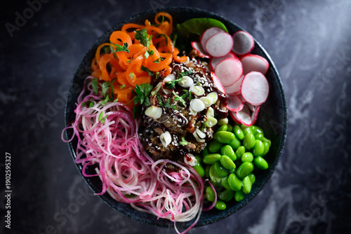 Photos A colorful bowl of food with a mix of vegetables and meat