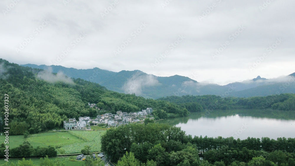 Obraz premium Hongcun Village Anhui China - Misty Mountains and Traditional Architecture