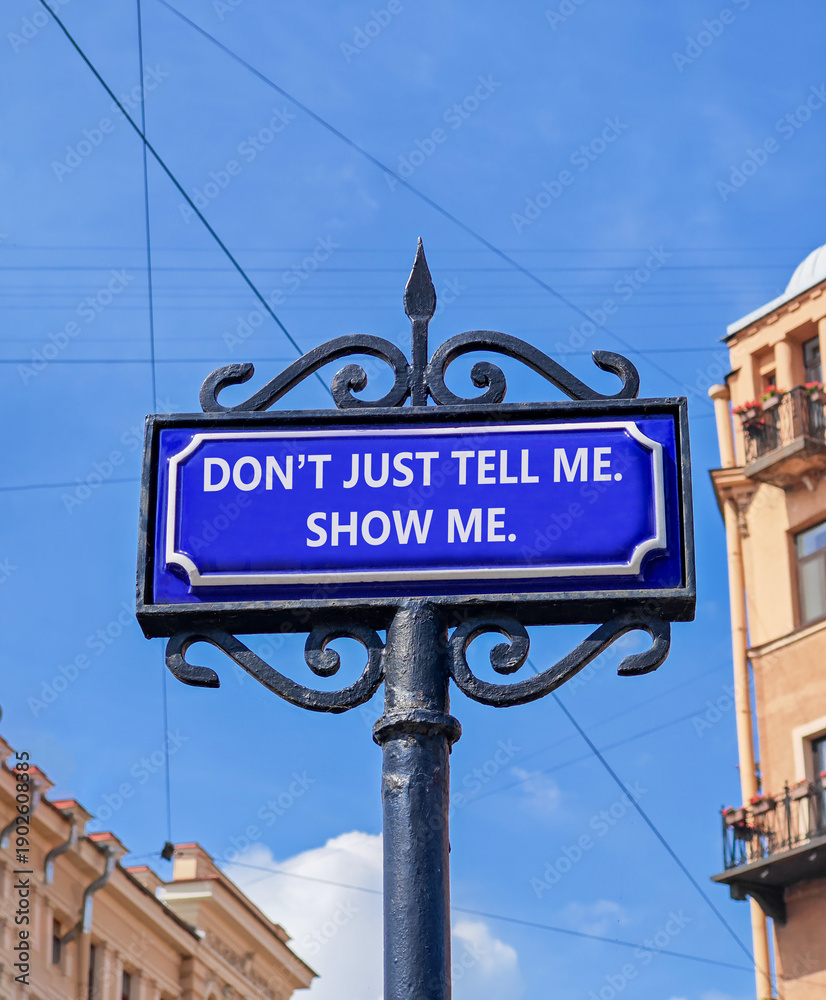 Obraz premium Tell or show symbol. Concept words Do not just tell me, show me beautiful blue road sign. Beautiful blue sky background. Business tell or show concept. Copy space.