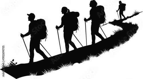 Hikers in silhouette walking on a hill with trekking poles