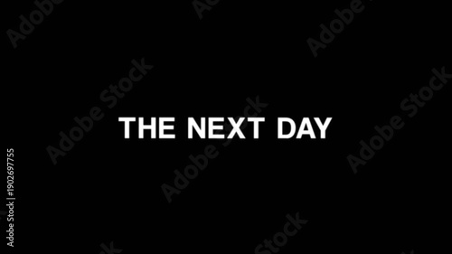 Simple and clean text animation displaying the phrase the next day in white typography on a dark background, perfect for storytelling, timelines, and cinematic video transitions.