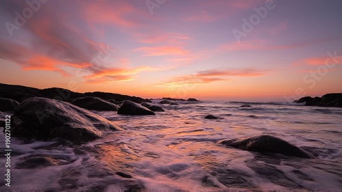 Serene rocky coastline at vibrant sunset