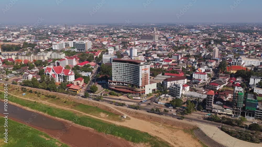 custom made wallpaper toronto digitalStatic high angle shot of a building under construction with scaffolding in Vientiane, Laos with busy street traffic from an aerial position