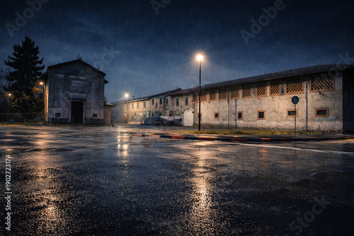Empty Industrial Street at Night After Rain with Wet Asphalt and Street Lights