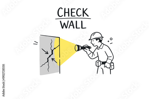 Male construction worker inspecting wall cracks with flashlight