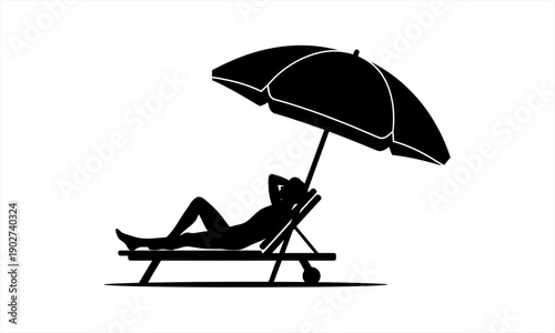 Silhouette of a person relaxing on a beach chair under an umbrella.