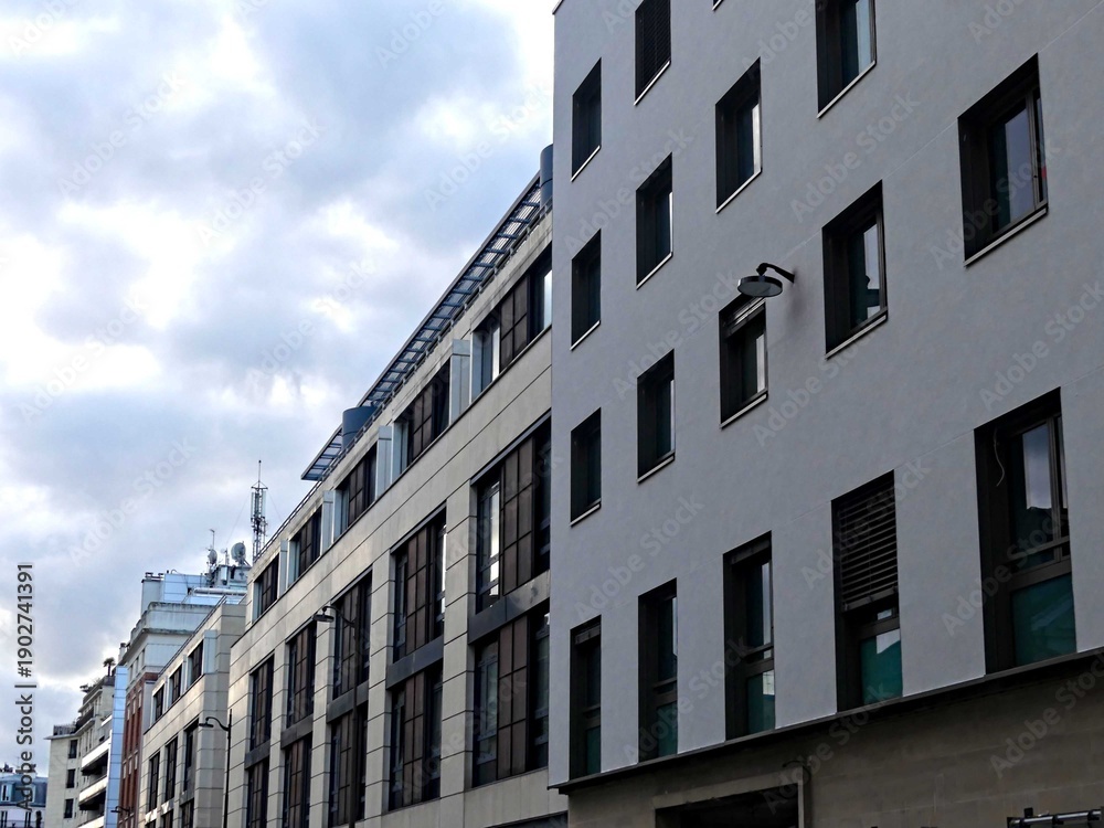 Obraz premium Paris, February 2026: Visit of the magnificent city of Paris, Capital of France - View on different facades of buildings built by Baron Haussmann