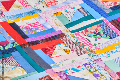 Colorful abstract patchwork background with diverse textile strips.