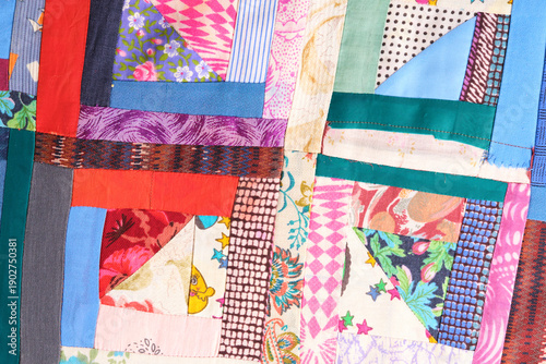 Colorful abstract patchwork background with diverse textile strips.