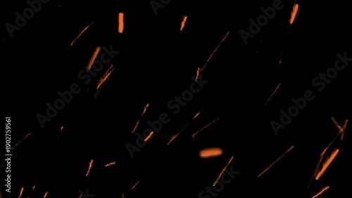 Glowing sparks fly through darkness