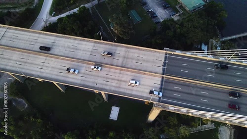 Vehicles crossing a suspension bridge over wide river in Florida
