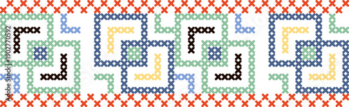 A colorful pattern of squares and triangles is embroidered on a white background